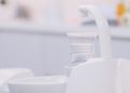 Patient rinsing mouth in dental clinic