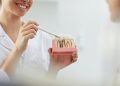 Smiling Dentist Explaining Tooth Implantation