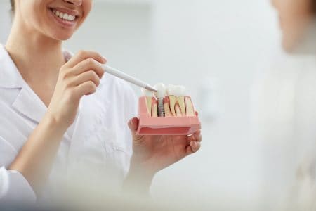 Smiling Dentist Explaining Tooth Implantation