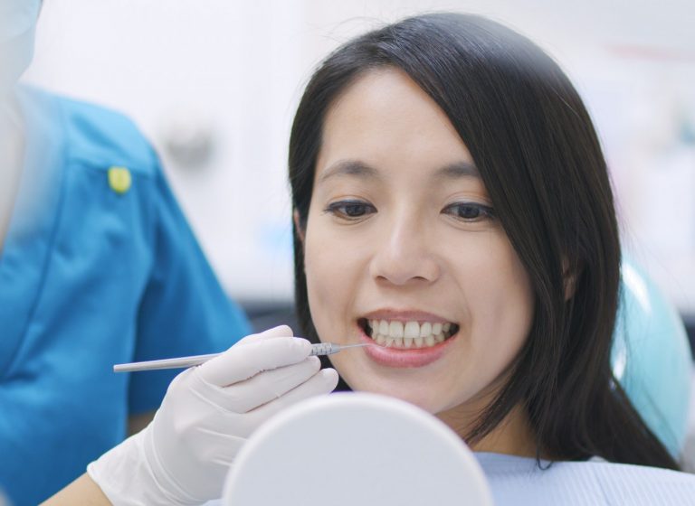 Woman on the inspection of the teeth in dentistry